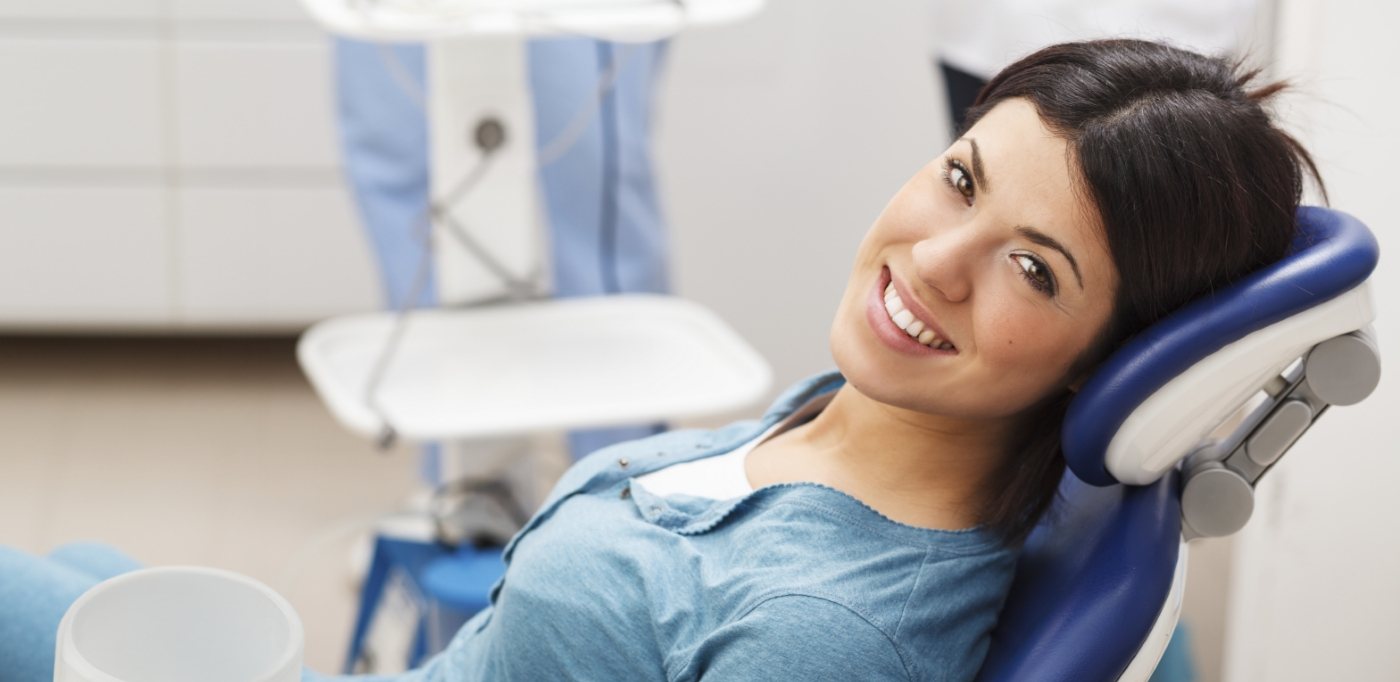 Young woman smiling and leaning back in dental chair