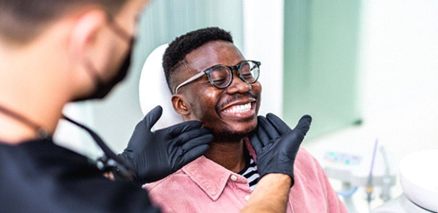 Dentist looking at smiling patient's teeth