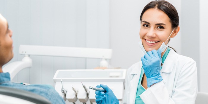 Dentist smiling at patient's dental exam